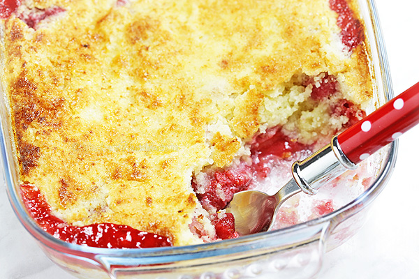 Strawberry Dump Cake - probably the easiest cake ever! Fresh strawberries, cake mix and butter dumped in a cake pan, baked and served with vanilla ice cream. Yum!
